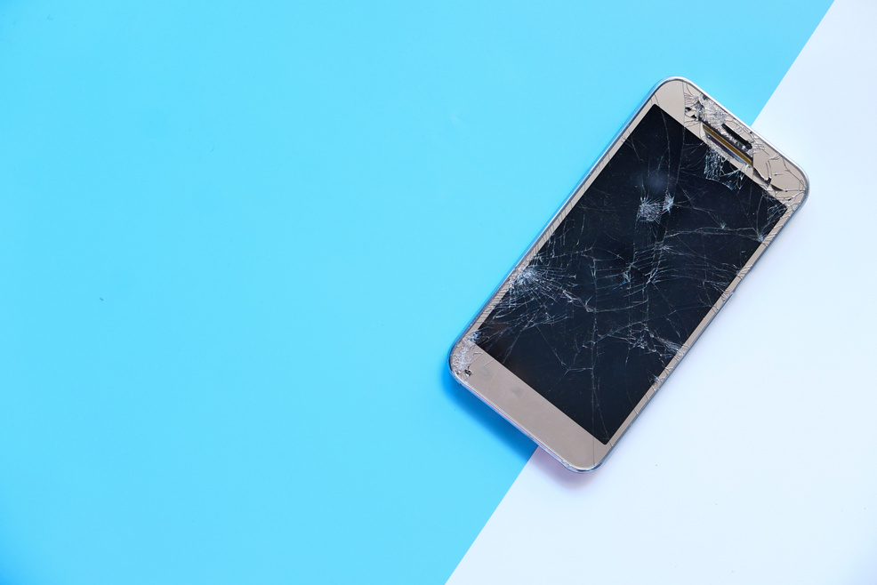 Top View of Broken Smart Phone on Color Background